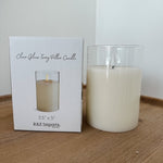 Clear glass candle with packaging on a wooden surface