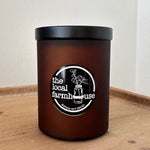 Black cylindrical container with black lid on a wooden surface