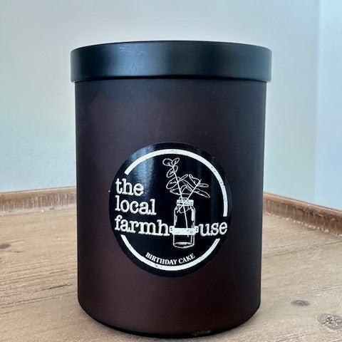 Black container with a logo on a wooden surface