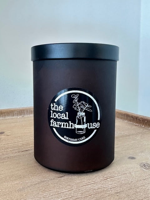 Black container with a logo on a wooden surface