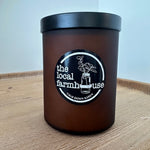 Black container with black lid on a wooden surface