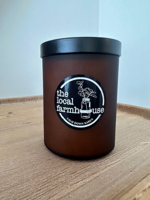 Black container with black lid on a wooden surface