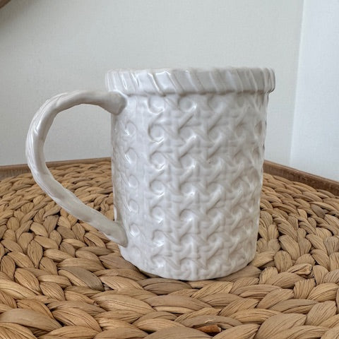 White textured mug on a woven mat