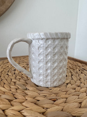 White textured mug on a woven mat
