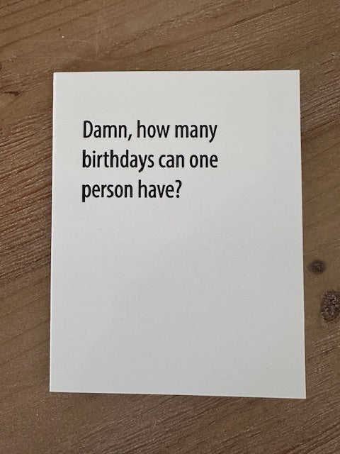 White card with black text on a wooden surface