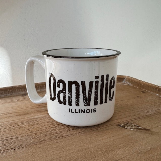 White mug with 'Danville, Illinois' text on a wooden surface