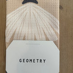 Patterned kitchen tea towel with a label on a wooden surface