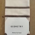 Kitchen tea towel with 'Geometry' branding on a wooden surface