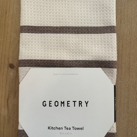 Kitchen tea towel with 'Geometry' branding on a wooden surface