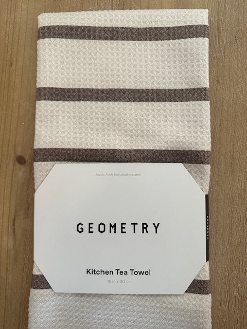 Kitchen tea towel with 'Geometry' branding on a wooden surface