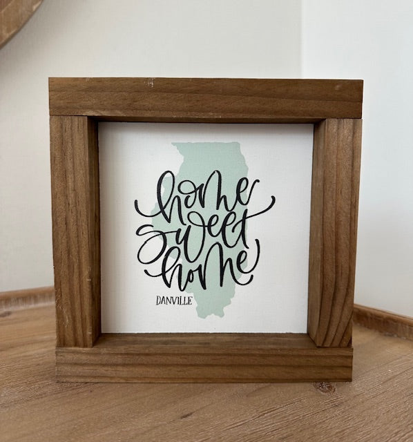 Wooden frame with 'Home Sweet Home, Danville' text on a white background