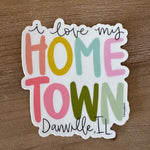 Colorful sticker with text 'I love my hometown Danville, IL' on a wooden surface