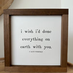 Framed quote by F. Scott Fitzgerald on a wooden surface