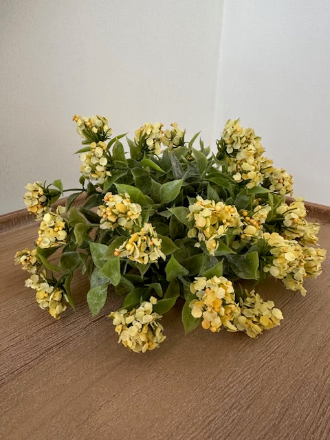 Bouquet of yellow flowers on a wooden surface