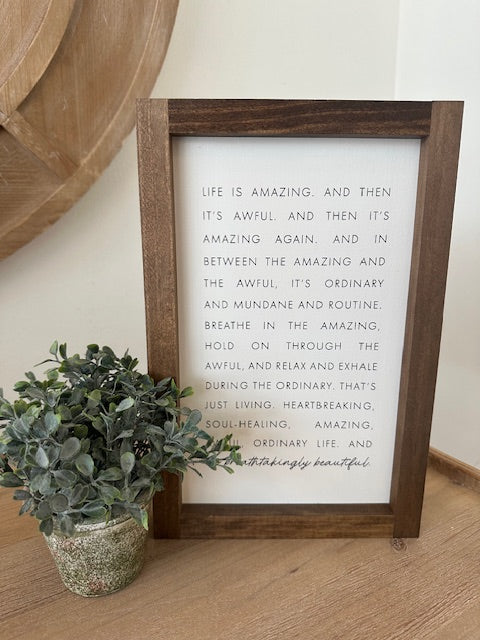 Framed motivational quote on a wall with decorative elements