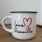 White mug with 'Love Danville' text and red heart on a wooden surface