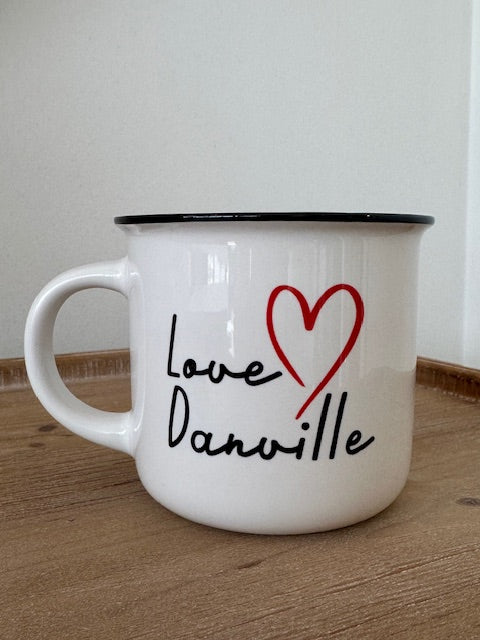 White mug with 'Love Danville' text and red heart on a wooden surface