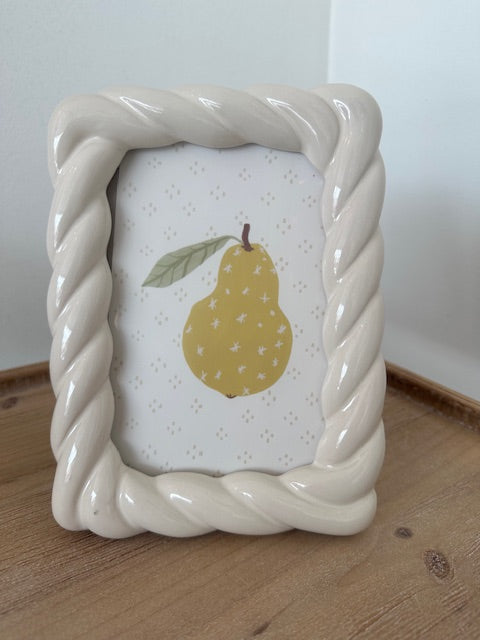 Decorative soap dish with a pear design on a wooden surface