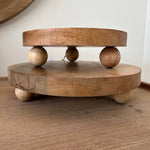 Wooden toy with round discs and beads on a wooden surface