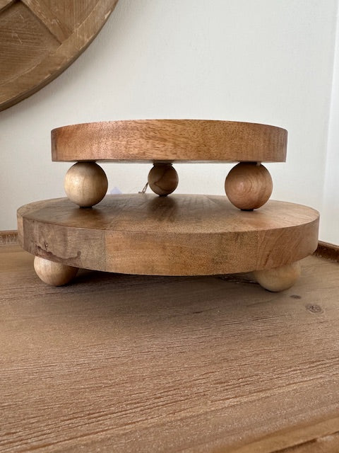 Wooden toy with round discs and beads on a wooden surface