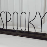 spooky ghost sign with wooded base