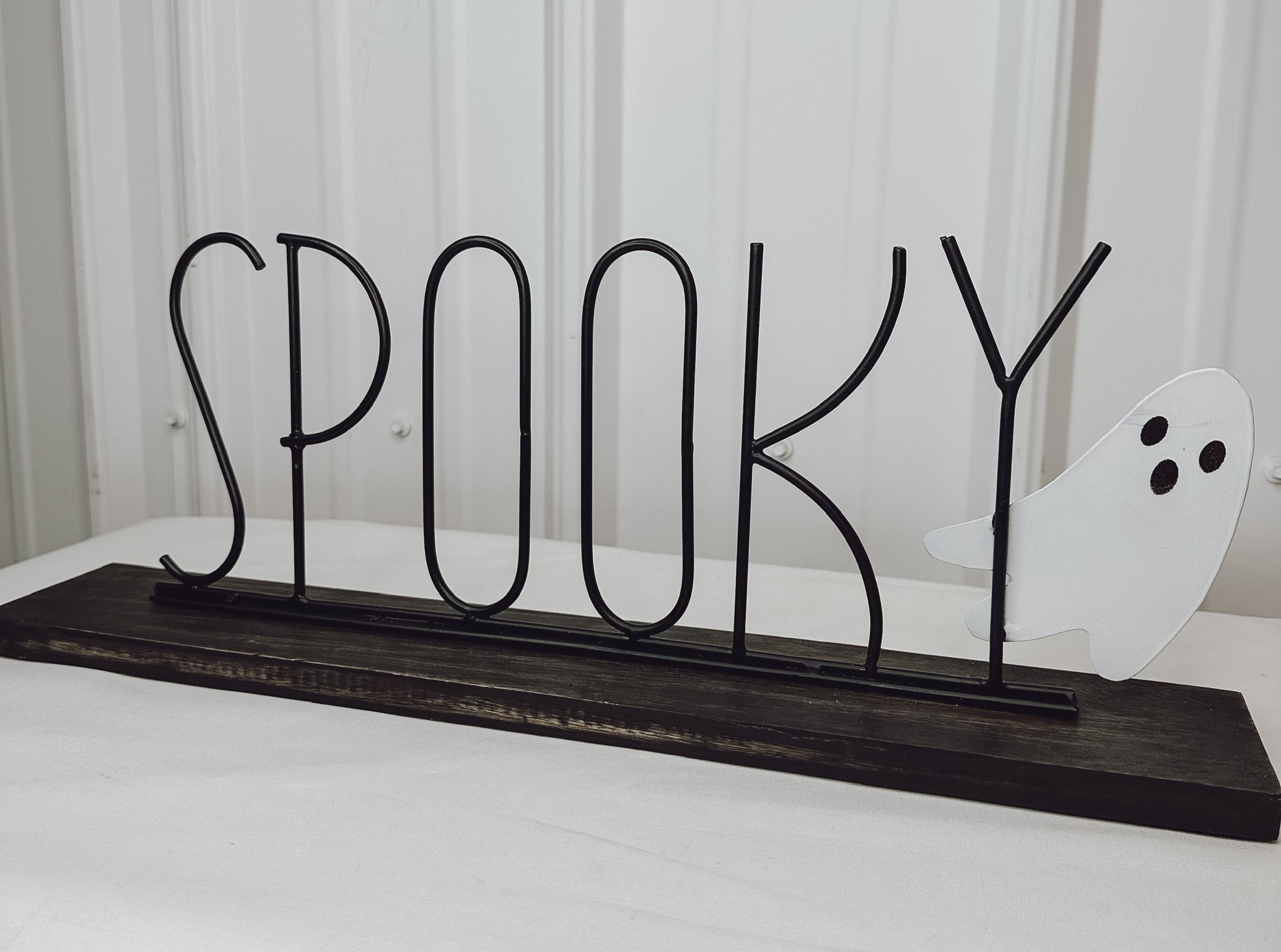 spooky ghost sign with wooded base